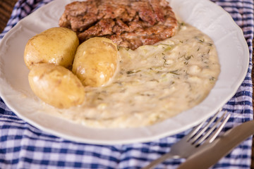 green pumpkin sauce with dill, new potatoes and pork medalions