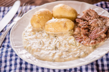 green pumpkin sauce with dill, new potatoes and pork medalions