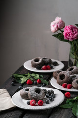 donuts, berries, flowers, dark, old wooden backdrop, bright effect