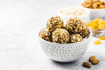 Raw dried fruit, oatmeal, nuts energy balls. Selective focus, space for text.