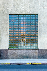 Front view of one large mosaic window on a city building.
