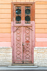 Old wooden door with beautiful carving in the city Saint-Petersburg