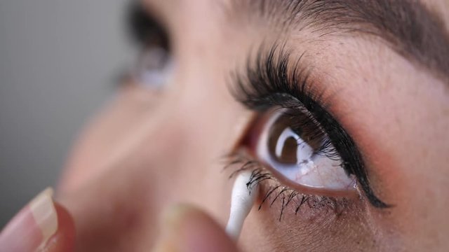 beautician using cotton bud makeup beauty eyelash