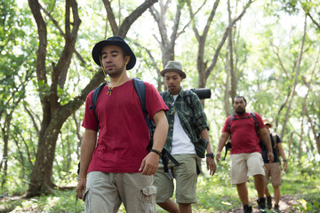 asian hiker walking in the forest