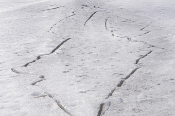 crack in the ice covered with snow even in winter sunlit .