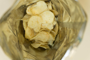 heap of potato crisps on white background .
