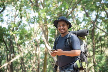 Naklejka na ściany i meble man using mobile phone in the forest