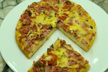 Slice of hot pizza large cheese lunch or dinner crust seafood meat topping sauce. with bell pepper vegetables delicious tasty fast food italian traditional on wooden board table classic in side view .