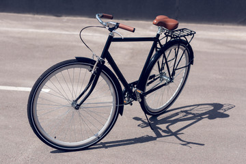 Fototapeta na wymiar close up view of retro bicycle parked on street