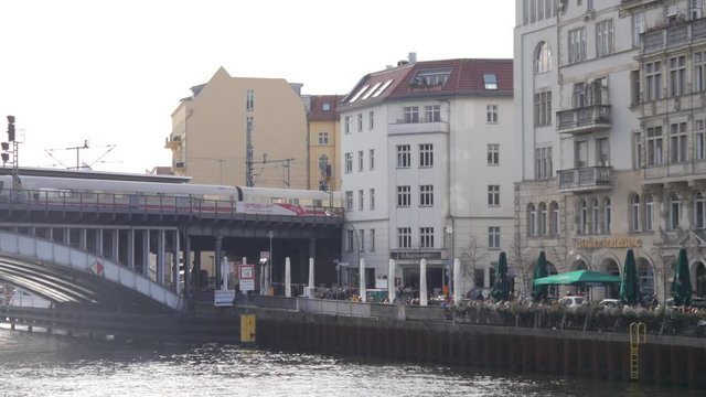 Berlin city center, U-Bahn train goes from station Friedrichstrasse over river Spree bridge