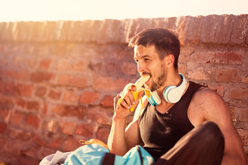 Resting with snack after fitness workout and exercising. - obrazy, fototapety, plakaty