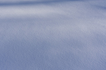 background of fresh snow texture in blue tone .