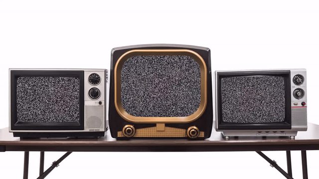 Three vintage televisions on white with dissolve to static and chroma green screens.