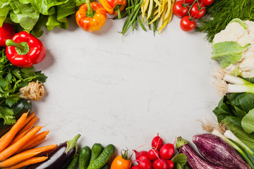 Obraz na płótnie Canvas Stone background with a border of fresh vegetables.