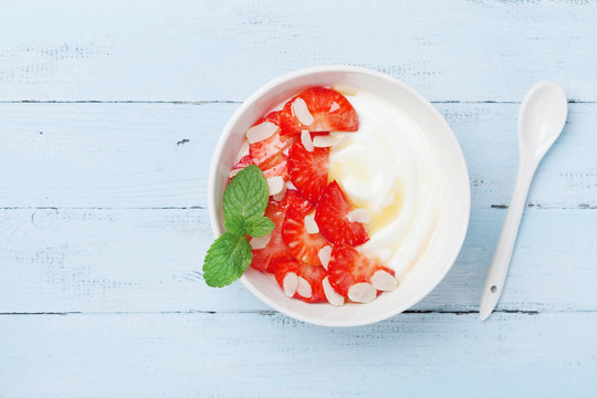 Greek Yogurt With Strawberry And Honey For A Healthy Breakfast. Top View.