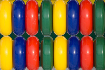 Many colorful plastic pieces in a kids' ballpit .
