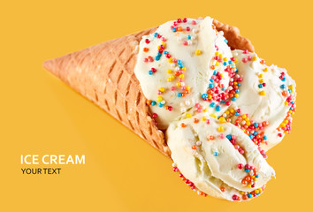 ice cream balls with colored sugar sprinkles in a Waffle Cone on a yellow Background. Vanilla ice cream in a waffle cone.