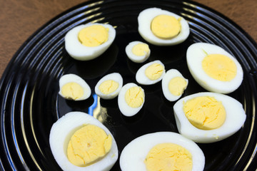 two halves of boiled eggs on wooden rustic background. the view from the top .