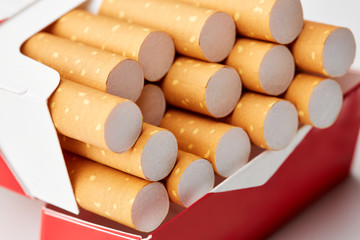 cigarettes in a pack close-up on a white background. Drug addiction. Smoking of tobacco. cancer....