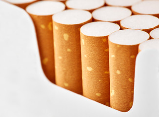 cigarettes in a pack close-up on a white background. Drug addiction. Smoking of tobacco. cancer....