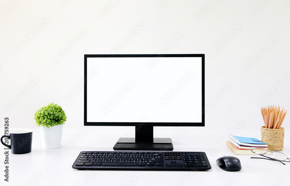 Poster front view blank screen computer with mouse, keyboard,pencils and tree vase in modern office