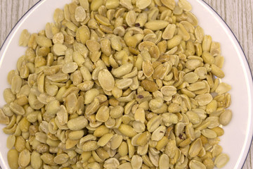 peanuts, salt, put in a cup. Brown was placed on the wooden floor.