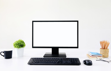 front view blank screen Computer with mouse, keyboard,pencils and tree vase in Modern office