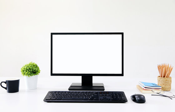 front view blank screen Computer with mouse, keyboard,pencils and tree vase in Modern office