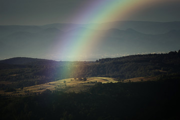 Naklejka na ściany i meble rainbow landscape, summer evening with rainbow over hills