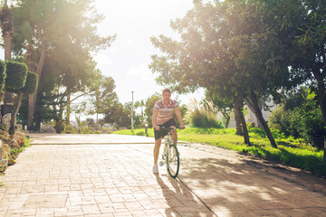 Young fit man during a bike ride on a sunny day.