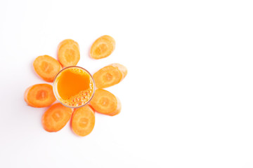 Carrot juice with carrot slices, top view.