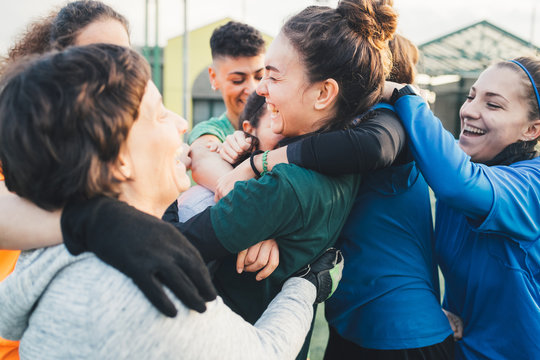 Football players jubilant and hugging on pitch