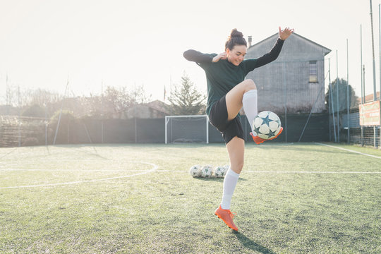Football player practising on football pitch