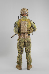 Special forces soldier with rifle on white background.