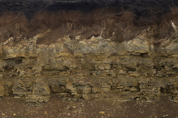 Soil cut-sandstone, stones, sand structure and layers