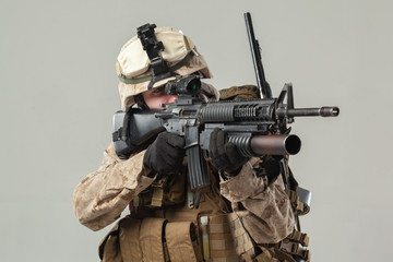 Soldier in camouflage holding rifle