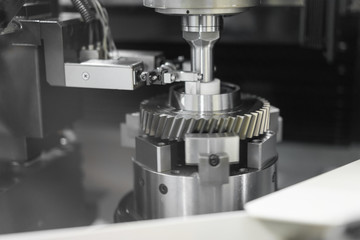 High precision CNC machining center working, operator machining and grinding automotive sample gear part process