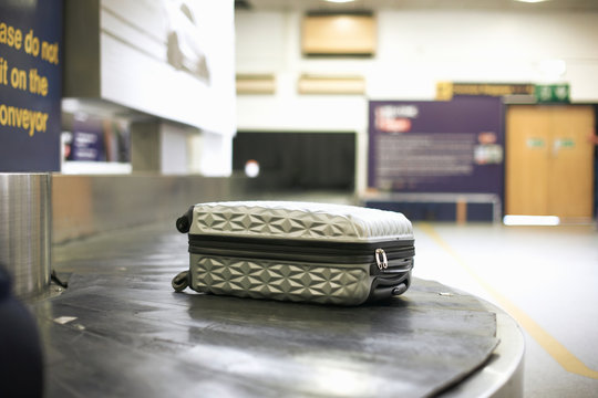 Wheeled suitcase on carousel in airport