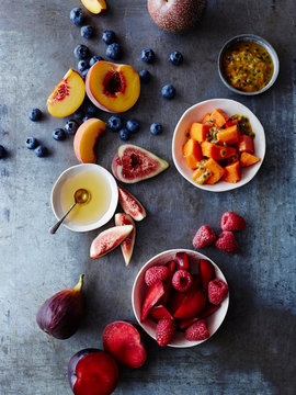 Still life of food bowls and fresh fruit, overhead view