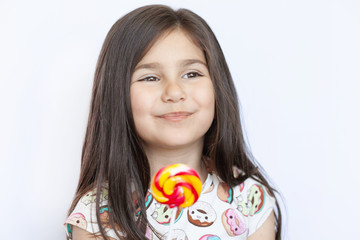 Beautiful cute little girl eating lollipop