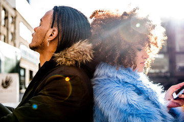 Portrait of couple sitting back to back