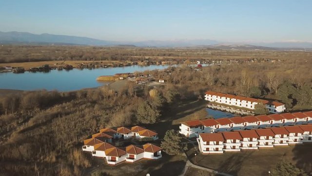 Aerial view of  small green village from above near lake in Montenegro
