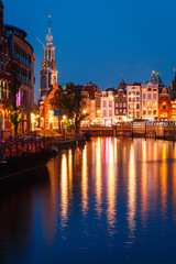 Fototapeta premium Evening building on the streets and amsterdam channels with illumination