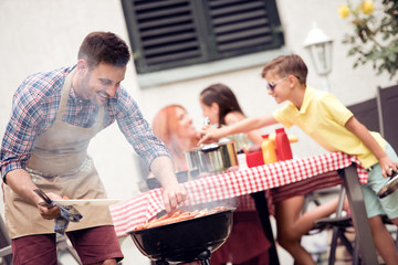 Young family make barbecue at their home