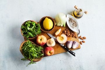 fresh ripe ingredients on a cutting wooden board on the table for summer salad recipes. healthy cuisine