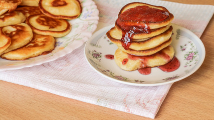 pancakes on a white plate with jam