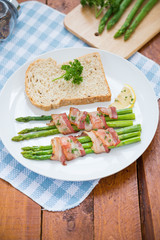 Fresh Young Asparagus Wrapped in Prosciutto Meat and Grilled on pan


