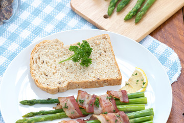 Fresh Young Asparagus Wrapped in Prosciutto Meat and Grilled on pan

