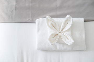 Fototapeta na wymiar Top view of white fresh towel on bed