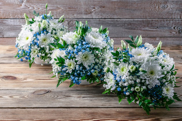 Wedding bouquets bridesmaids in white and blue chrysanthemums on a wooden background
